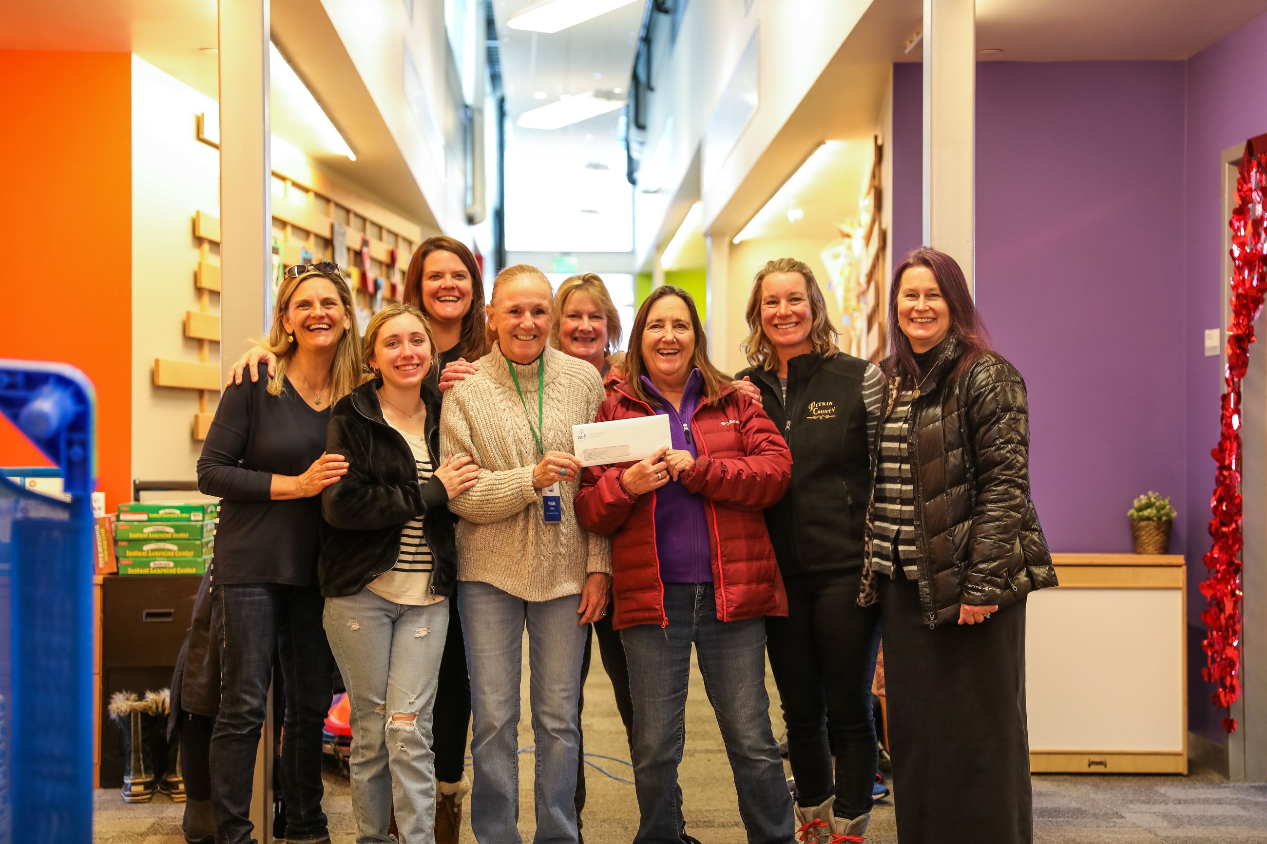 Child care providers at Aspen Country day pose for a photo with commissioner Patti Clapper.