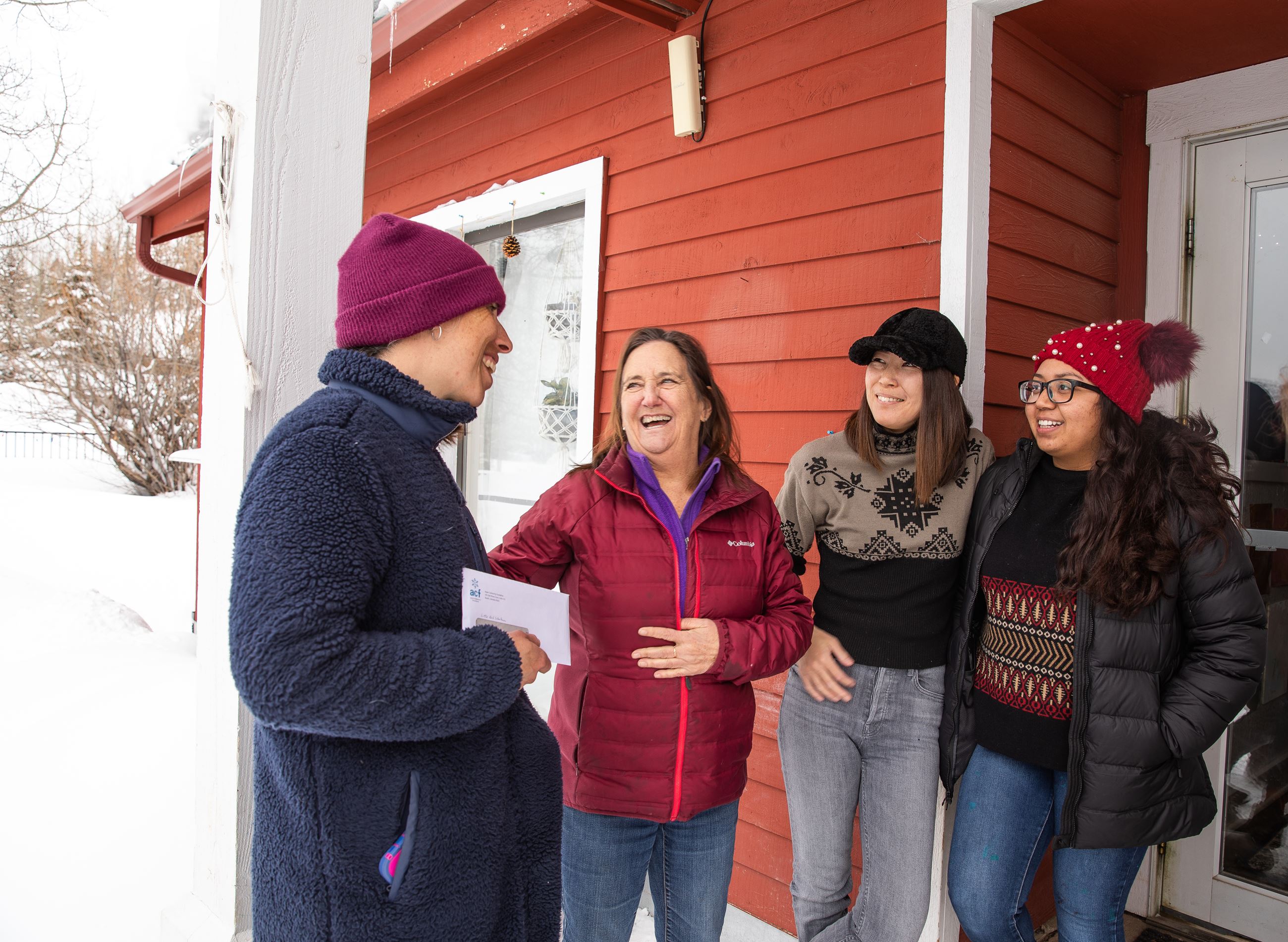 Commissioner Patti Clapper converses with Little Red Schoolhouse child care providers.